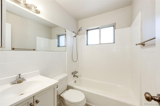 full bathroom with toilet, tile walls, backsplash, tiled shower / bath combo, and vanity