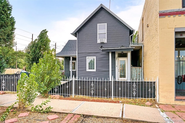 back of property featuring a fenced front yard