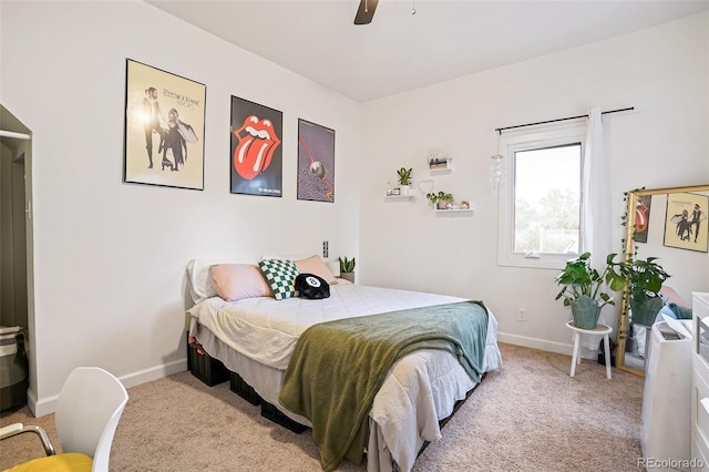 carpeted bedroom with ceiling fan and baseboards