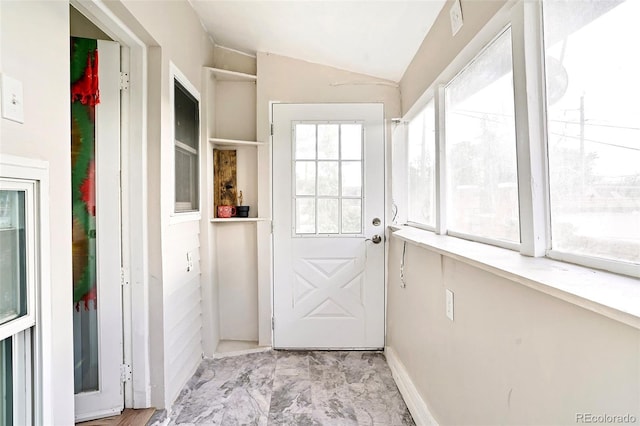 unfurnished sunroom featuring lofted ceiling