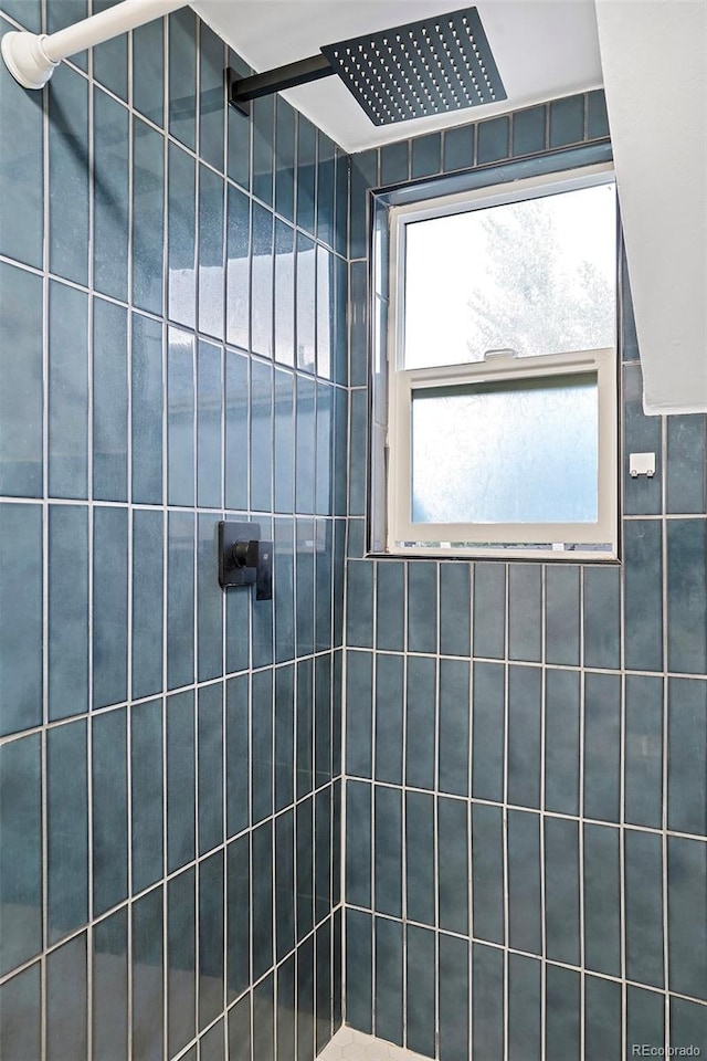 full bath featuring tiled shower