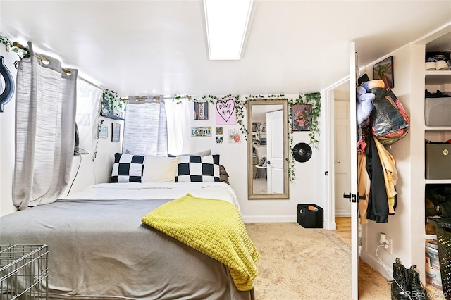 bedroom featuring baseboards and carpet