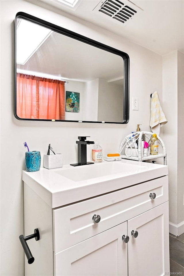 bathroom with visible vents and vanity