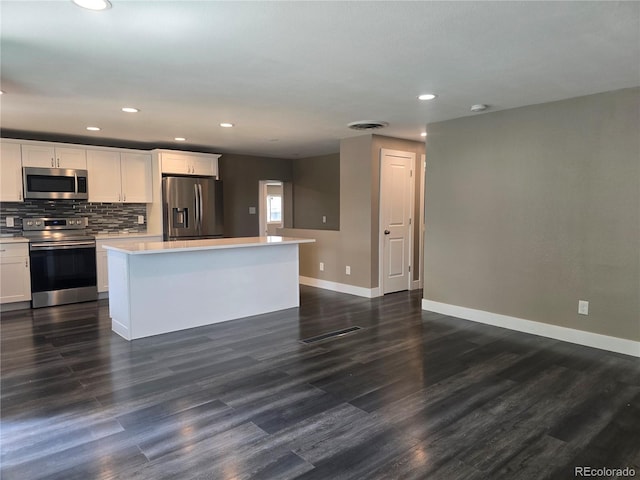 795 Vivian Ct, Lakewood, CO 80401 - kitchen featuring appliances with stainless steel finishes, baseboards, a kitchen island, white cabinets, and recessed lighting