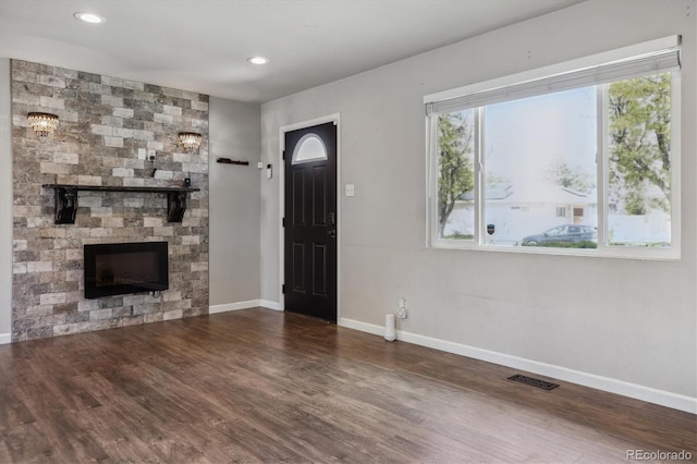 765 Iola St, Aurora, CO 80010 - foyer featuring baseboards, wood finished floors, a stone fireplace, and recessed lighting