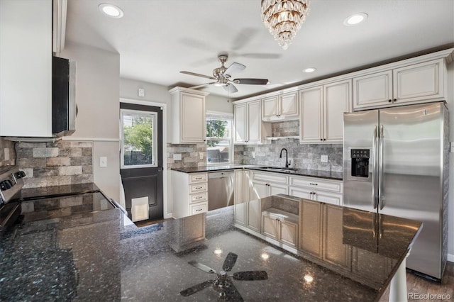 765 Iola St, Aurora, CO 80010 - kitchen featuring appliances with stainless steel finishes, a ceiling fan, a sink, decorative backsplash, and dark stone countertops