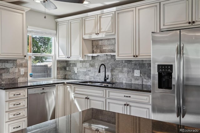 765 Iola St, Aurora, CO 80010 - kitchen featuring appliances with stainless steel finishes, a sink, tasteful backsplash, dark stone counters, and ceiling fan