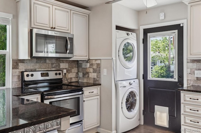 765 Iola St, Aurora, CO 80010 - laundry area featuring stacked washer and clothes dryer and healthy amount of natural light