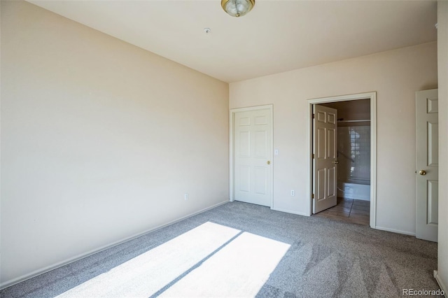 2491 Fountain Greens Blvd Unit B1, Grand Junction, CO 81505 - unfurnished bedroom with carpet flooring and connected bathroom