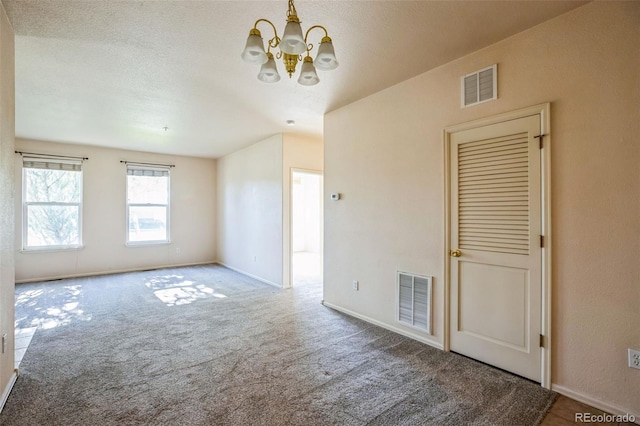 2491 Fountain Greens Blvd Unit B1, Grand Junction, CO 81505 - carpeted empty room featuring a chandelier and baseboards