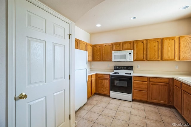 2491 Fountain Greens Blvd Unit B1, Grand Junction, CO 81505 - kitchen with white appliances, brown cabinets, light countertops, and recessed lighting