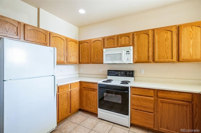 2491 Fountain Greens Blvd Unit B1, Grand Junction, CO 81505 - kitchen with white appliances, light countertops, light tile patterned floors, brown cabinets, and recessed lighting