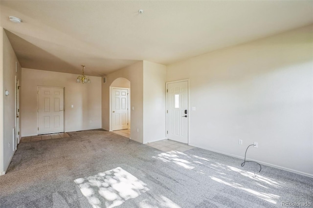2491 Fountain Greens Blvd Unit B1, Grand Junction, CO 81505 - unfurnished living room featuring arched walkways and carpet