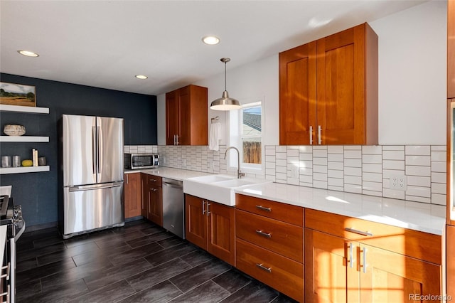 kitchen with decorative light fixtures, sink, stainless steel appliances, and dark wood-type flooring