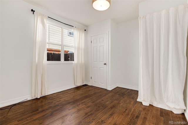 spare room featuring dark hardwood / wood-style floors