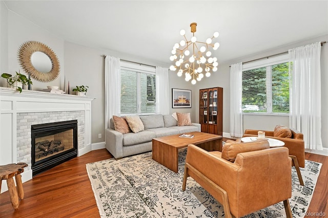 549 Milwaukee St, Denver, CO 80206 - living room featuring wood finished floors, a fireplace, and a chandelier