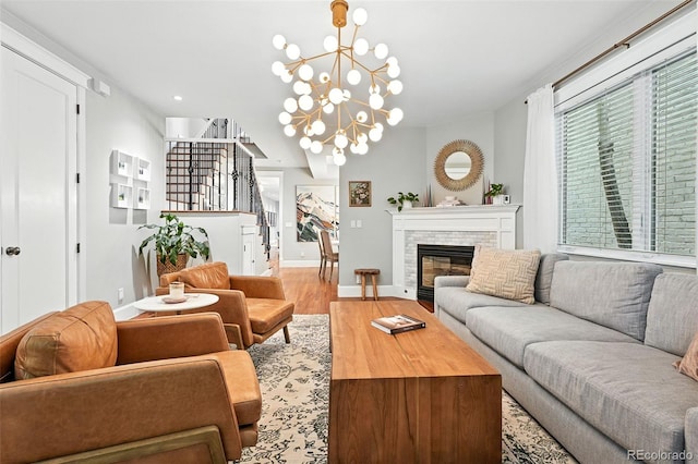 549 Milwaukee St, Denver, CO 80206 - living area with stairway, wood finished floors, a glass covered fireplace, a chandelier, and recessed lighting