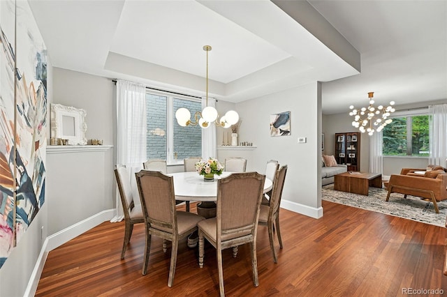549 Milwaukee St, Denver, CO 80206 - dining room with a chandelier, a raised ceiling, and wood finished floors