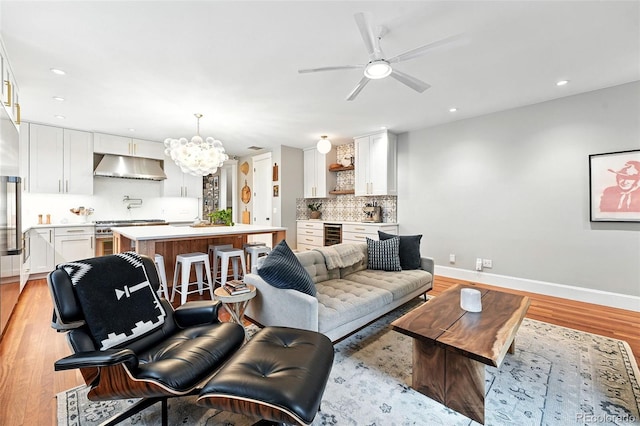 549 Milwaukee St, Denver, CO 80206 - living room with beverage cooler, a chandelier, ceiling fan, light wood-style floors, and recessed lighting