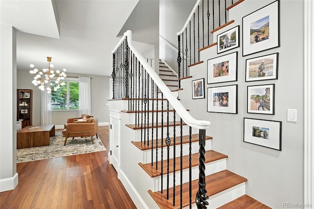 549 Milwaukee St, Denver, CO 80206 - staircase featuring wood finished floors and a chandelier