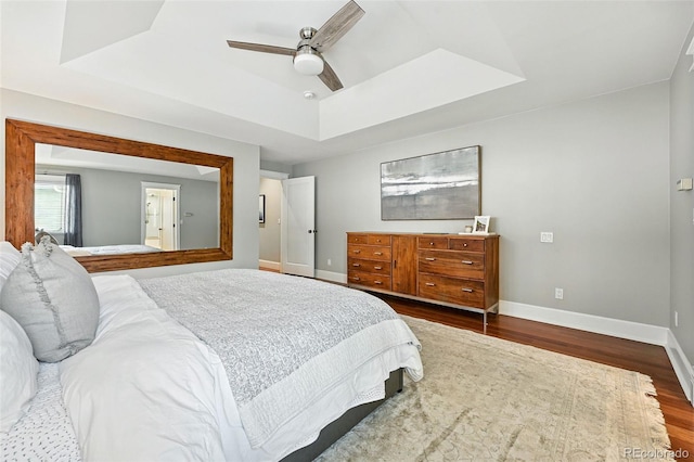 549 Milwaukee St, Denver, CO 80206 - bedroom with dark wood finished floors, a tray ceiling, and ceiling fan