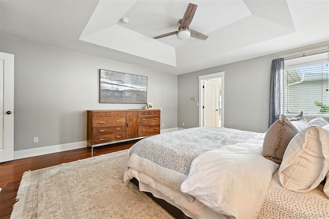 549 Milwaukee St, Denver, CO 80206 - bedroom featuring a tray ceiling, wood finished floors, and a ceiling fan