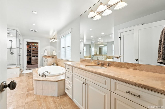 549 Milwaukee St, Denver, CO 80206 - full bath featuring a shower stall, vanity, a bath, a spacious closet, and recessed lighting