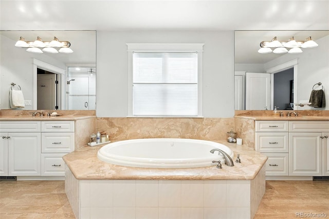 549 Milwaukee St, Denver, CO 80206 - full bathroom featuring two vanities, a garden tub, and a stall shower