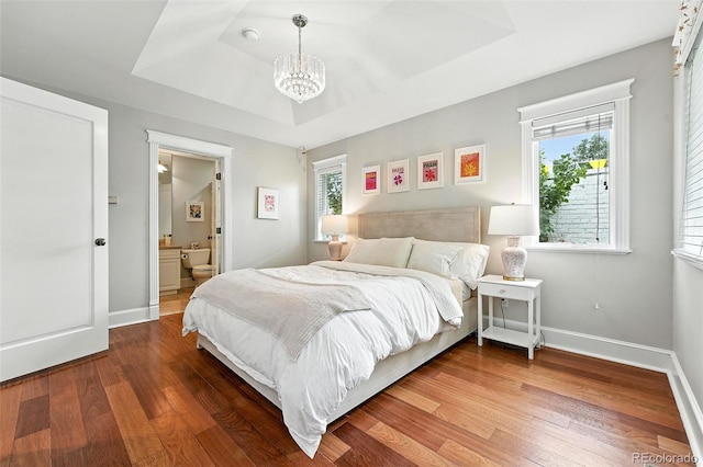 549 Milwaukee St, Denver, CO 80206 - bedroom featuring a tray ceiling, wood finished floors, a chandelier, and ensuite bathroom