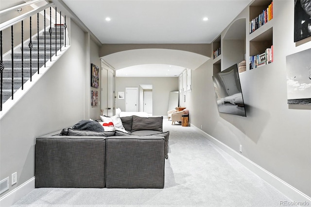 549 Milwaukee St, Denver, CO 80206 - carpeted living room featuring arched walkways, stairs, and recessed lighting