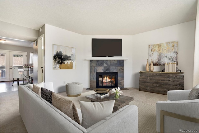 living room with radiator, a fireplace, carpet floors, and a textured ceiling