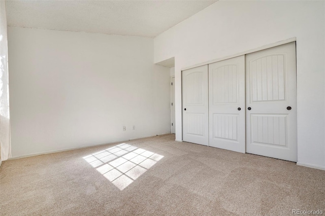 unfurnished bedroom with a closet and carpet