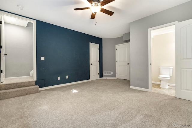 unfurnished bedroom with a ceiling fan, carpet, visible vents, baseboards, and connected bathroom