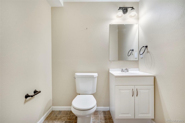 bathroom with vanity, tile patterned floors, toilet, and baseboards