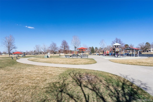 view of community with a gazebo, playground community, and a yard