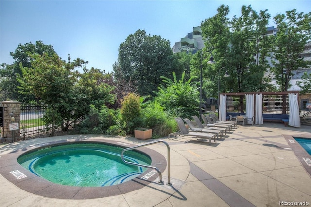 view of swimming pool with a community hot tub and a patio area