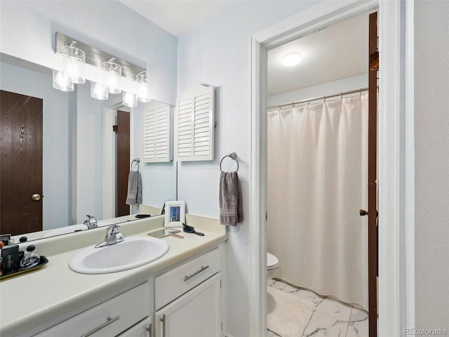 full bathroom with toilet, vanity, and marble finish floors