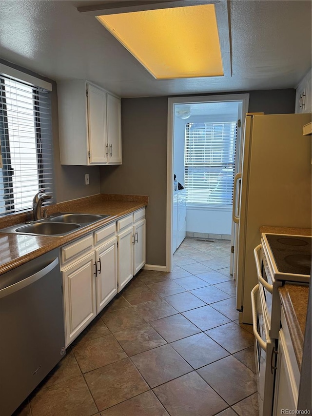 kitchen featuring white cabinetry, stainless steel dishwasher, white range with electric cooktop, and sink