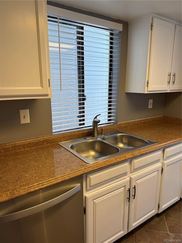 kitchen with white cabinetry and stainless steel dishwasher