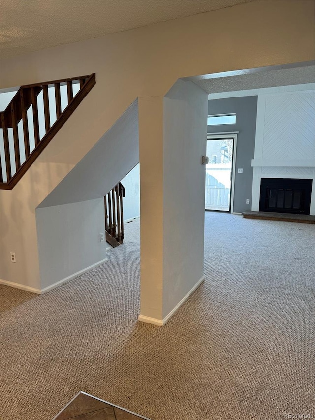 unfurnished living room with a fireplace and carpet flooring