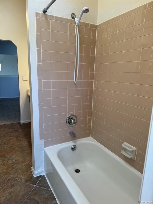 bathroom with tiled shower / bath and tile patterned floors