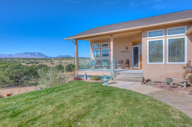 exterior space with a mountain view and a front yard