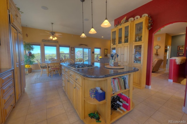 kitchen featuring light tile patterned floors, a kitchen island, and ceiling fan