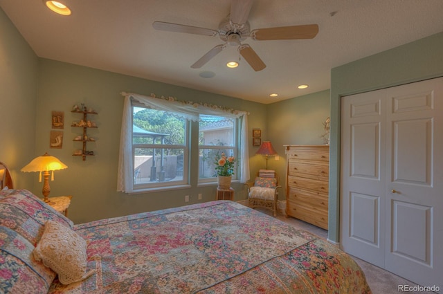 carpeted bedroom with ceiling fan and a closet