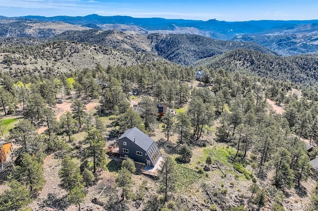 2037 Mockingbird Trl, Bailey, CO 80421 - view of subject property featuring a mountainous background and a heavily wooded area