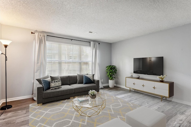 living room featuring hardwood / wood-style floors and a textured ceiling