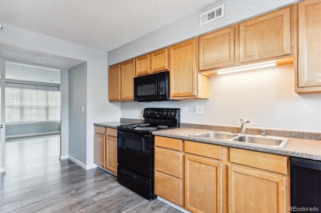 kitchen with wood-type flooring, light brown cabinets, sink, black appliances, and a textured ceiling