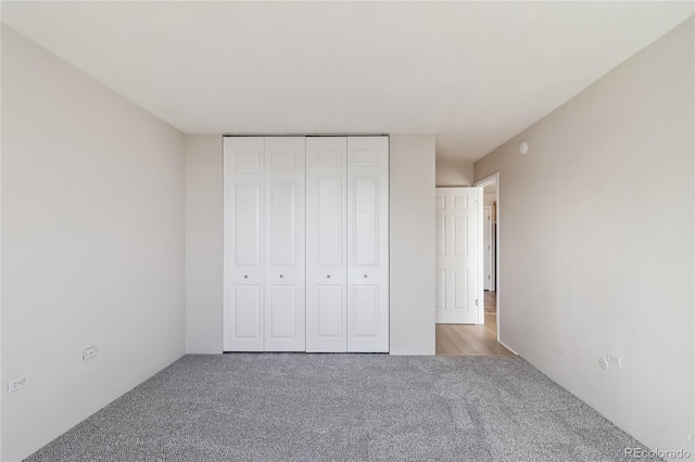 unfurnished bedroom featuring a closet and carpet floors