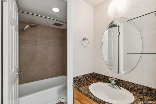 bathroom with vanity, toilet, and tub / shower combination