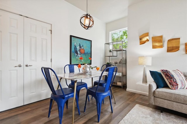 dining room with baseboards and wood finished floors